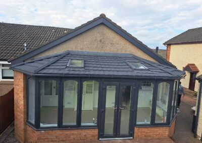 Modern conservatory with a solid tiled roof