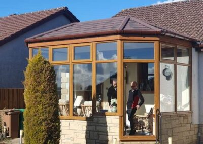 Oak-effect conservatory with a solid tiled roof