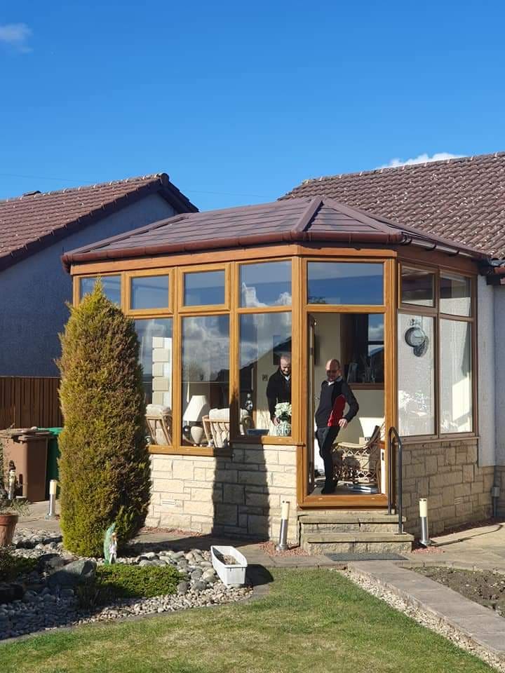 Oak-effect conservatory with a solid tiled roof