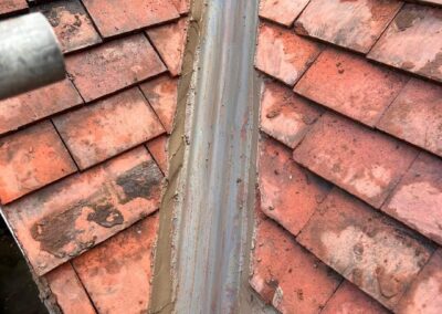 Clay tile roof with lead valley ready for repair