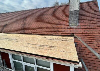 Storm-damaged roof section being made watertight