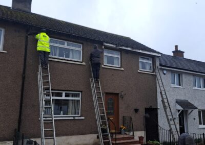 Guttering being fitted on a terraced house