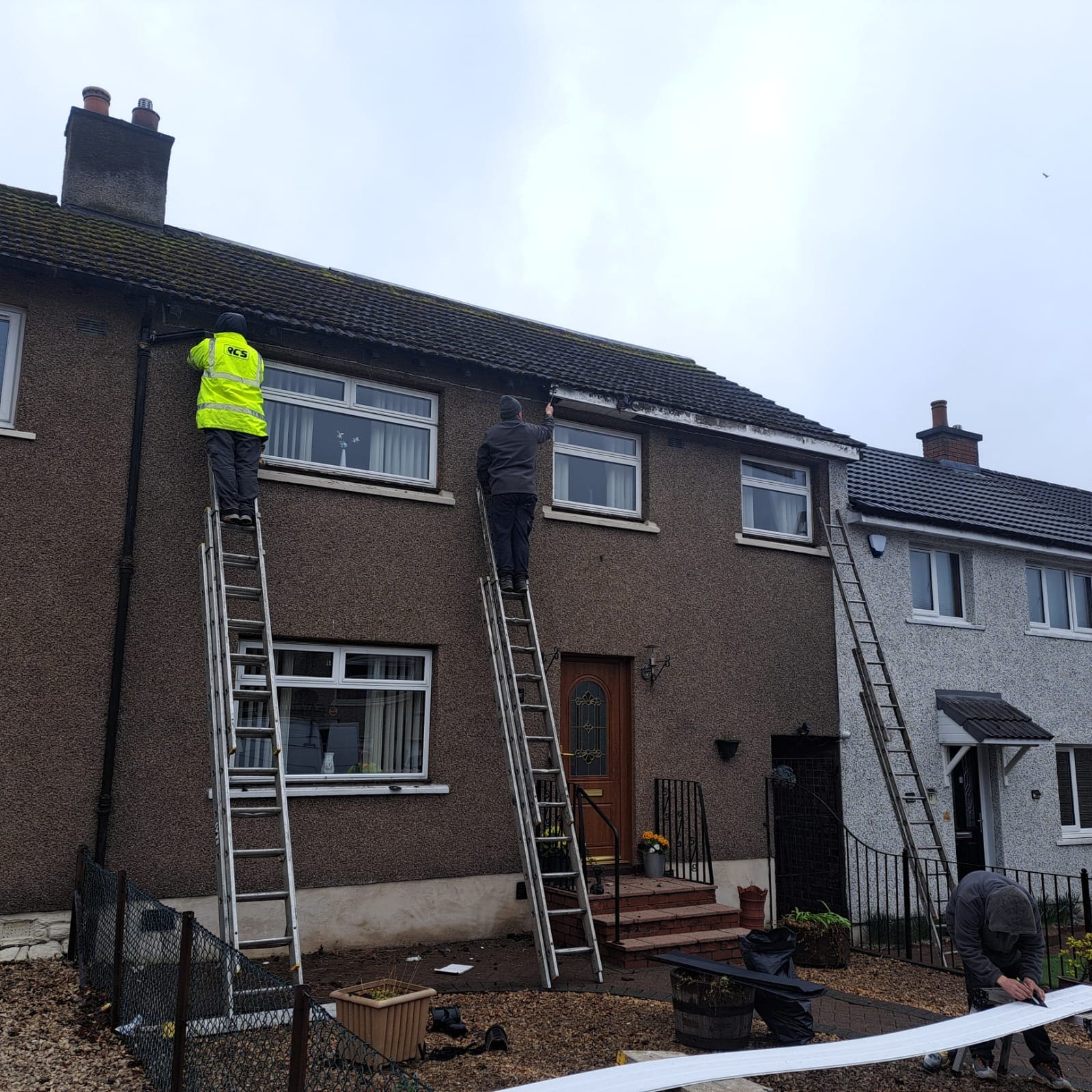 Guttering being fitted on a terraced house