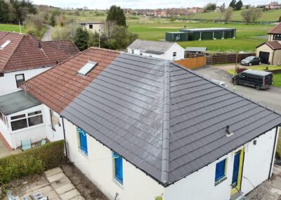 Hipped roof re-roofed in grey tiles