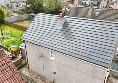 Newly re-roofed house with grey tiles