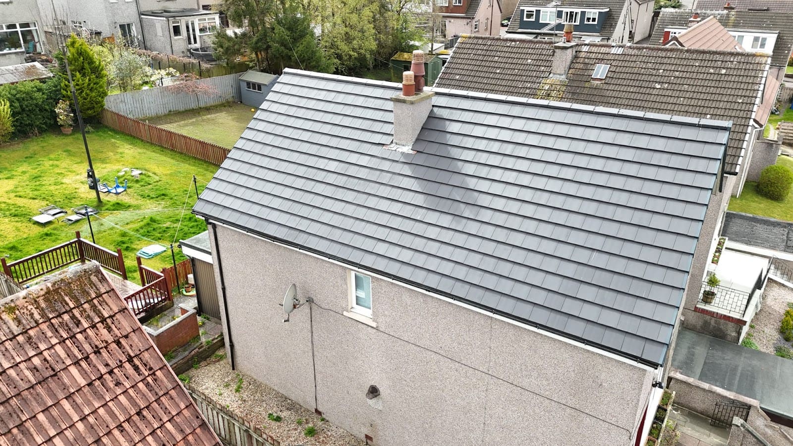 Newly re-roofed house with grey tiles