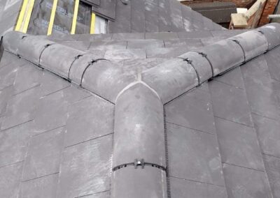 Slate roof hip repaired with new ridge