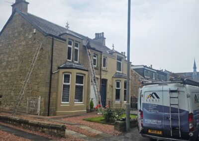 Kerse Roofing & Building van at a stone house