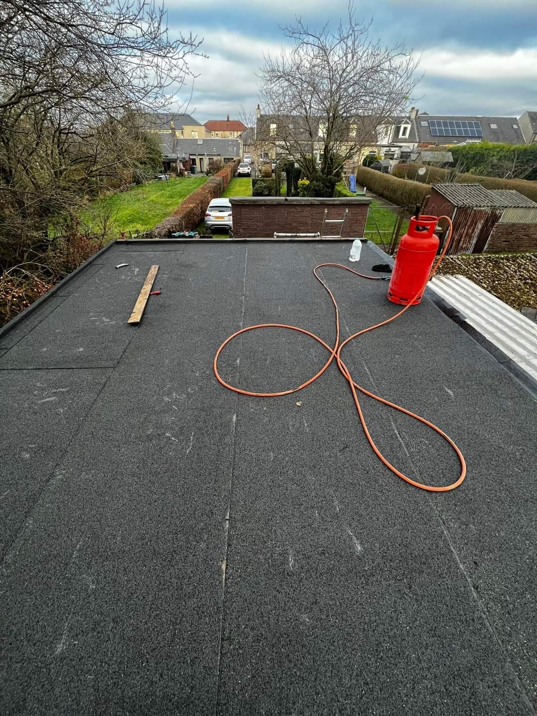 Flat roof being replaced with torch-on felt