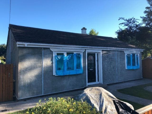 Fresh roughcast going on to a bungalow